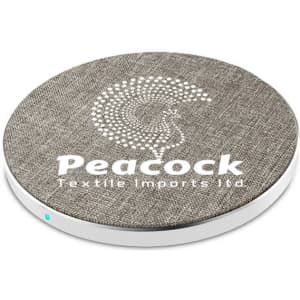 A round wireless charger in grey fabric with a white base and a logo.
