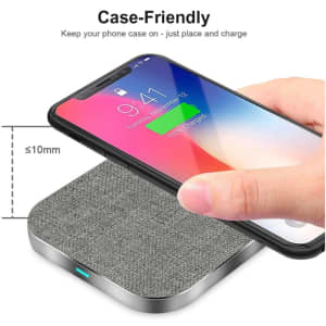 A square wireless charger with a grey fabric finish, designed to charge phones while in their case.