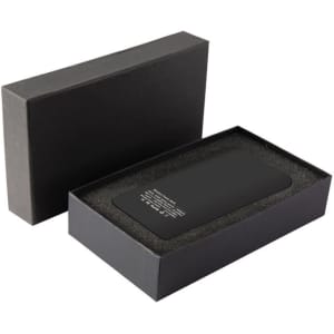 A black wireless power bank with a sleek design, presented in a matching black box with a cushioned interior.