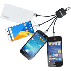 A charging cable in black with multiple connectors attached to three smartphones, including a white power bank.