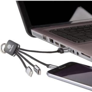 A charging cable with multiple connectors, featuring a black design and a keyring attachment, plugged into a laptop.