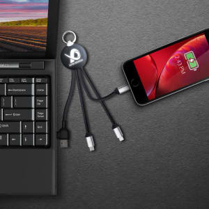 A black LED charge cable with multiple connectors attached to a laptop and smartphone, featuring a logo.
