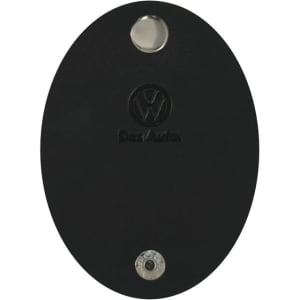 A black oval cable tidy with a metallic button and a logo. Suitable for managing cables and cords.