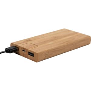 A bamboo wireless power bank in natural wood tones, featuring USB ports and a charging cable attached.