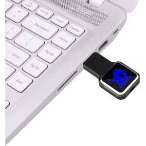 A black Oatley Flash Drive plugged into a laptop's USB port, with a visible logo and sleek design.