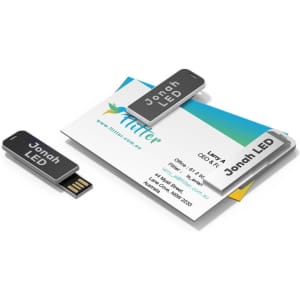 A black Jonah LED clip flash drive displayed alongside a business card, featuring a sleek and modern design.