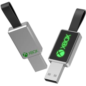 A silver USB flash drive with a black strap, featuring a green logo on one side.