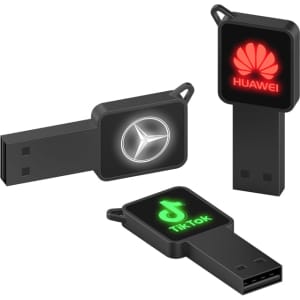 Three black flash drives featuring distinct logos in illuminated designs. Each drive has a USB connector and a different shape.