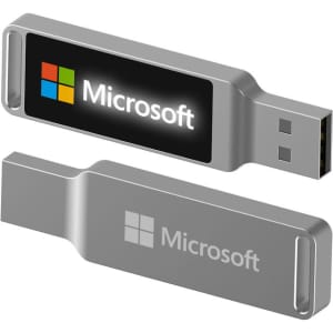 A silver LED flash drive with a logo, featuring a USB connector on one end and a smooth finish.