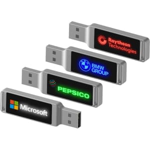 A set of four LED flash drives in silver, featuring various logos on illuminated displays.