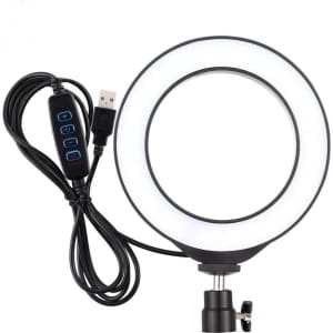 A 6-inch round LED halo light in white with a black adjustable stand and a connected USB cable featuring control buttons.