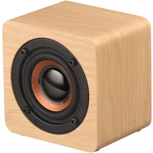 A wooden speaker with a square design and a circular speaker grille in the front, primarily light brown in colour.