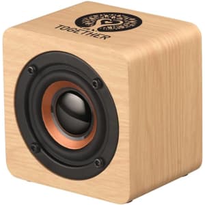 A wooden square speaker with a black speaker cone and a logo on the top, featuring warm tones in its design.