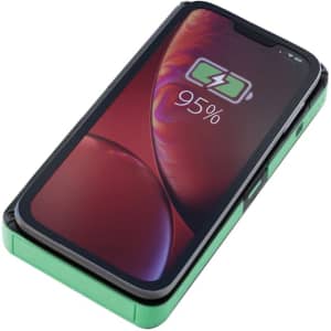 A green Europa Solar Wireless Power Bank with a phone displaying a charging indicator on the screen.