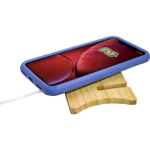 A blue wireless charging stand with a wooden base and a smartphone positioned on top, displaying a charging icon.