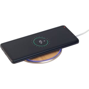 A bamboo wireless charger with a smartphone placed on top, featuring a circular LED light around the base.