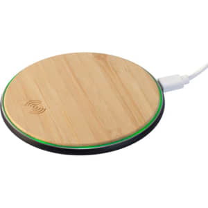 A round bamboo wireless charger with a black base and a subtle green light edge. It features a logo on the surface.
