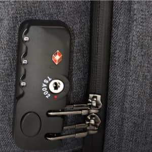 A close-up of a grey backpack zipper with a combination lock and branding on the side.