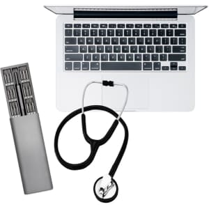 A silver tool kit with various bits, a black stethoscope, and a silver laptop keyboard. The kit includes a logo.
