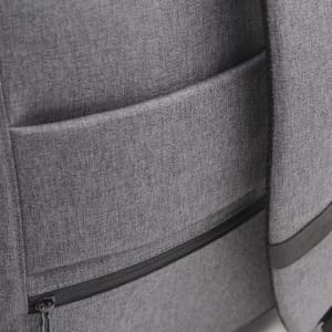A grey backpack featuring multiple pockets and a sleek design, with a logo on the surface.