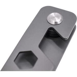 A grey metal keyring tool featuring a hexagon shape and a circular fastener. Includes a branded logo.