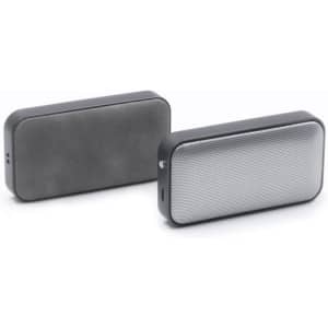 A pair of compact wireless speakers in black and silver, featuring a mesh grille and a sleek design.