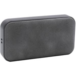 A compact grey wireless speaker with a smooth exterior and an embedded logo.