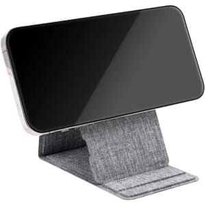 A wireless charger in grey fabric, designed to hold a smartphone upright for convenient charging.
