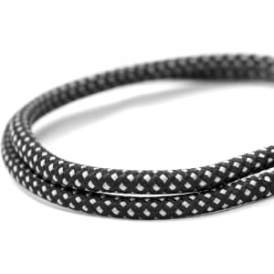 A charging cable in black with a white braided design, coiled elegantly on a white background.