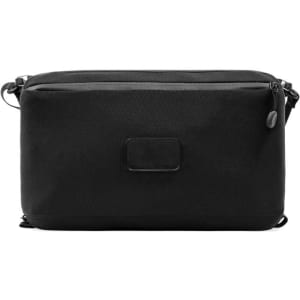 A black toiletry bag featuring a sleek design and a logo, with dual zippered compartments.