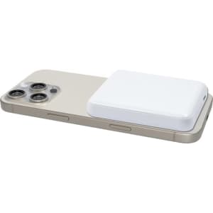 A smartphone in a light colour with a white magnetic wireless power bank on its back, featuring rounded edges.