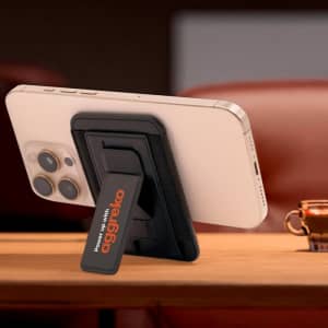 A phone stand featuring a black case with a logo, securely holding a smartphone in an upright position.