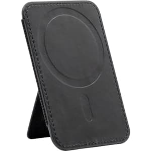 A black phone stand with a circular magnetised area and stitching details, featuring a logo on the surface.