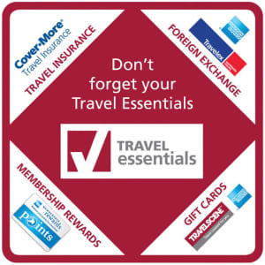 A red and white coaster featuring a central logo for "Travel Essentials" and icons for travel insurance, foreign exchange, membership rewards, and gift cards.