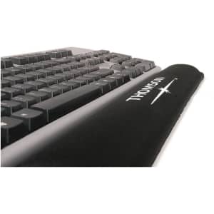 A black gel keyboard wrist rest positioned in front of a black keyboard, featuring a logo on the surface.