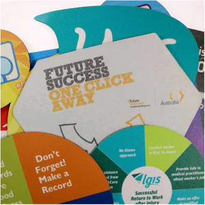 A collection of colourful mouse pads with various shapes, including a grey one featuring a graphic design and a logo.