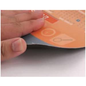 An orange and grey ultra-thin PVC mouse pad with a person’s hand resting on it, showcasing its flexibility.