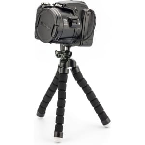 A black camera mounted on a flexible tripod with black foam grip legs and white rubber feet.