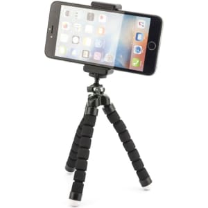A black Flex Tripod with adjustable legs and a smartphone mounted on top. Features a compact design for easy portability.