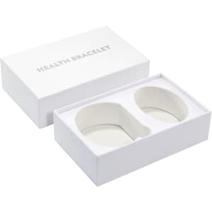 A large white gift box containing two health bracelets, featuring a simple, elegant design.