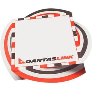 A stack of small note pads featuring a circular design in red, black, and white, with a logo.