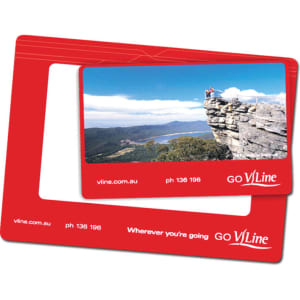 A red magnetic photo frame with an oval window and branding, featuring a scenic landscape photo.