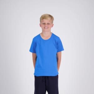 A blue kid's t-shirt with short sleeves, displayed on a young boy standing against a light background.