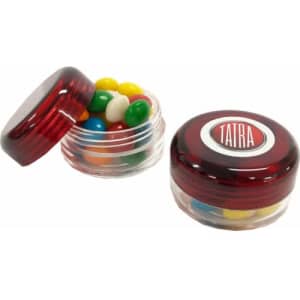 A small screw cap jar containing brightly coloured chewy fruit candies, with a red lid and a logo on top.