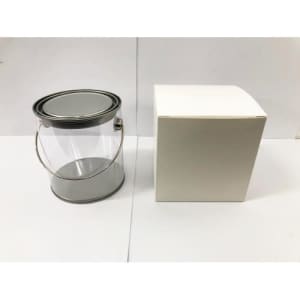 A transparent PVC bucket with a silver metal handle next to a plain white box.