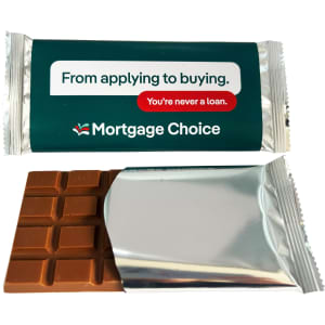 An 80g chocolate bar in a silver wrapper with a logo and green packaging, featuring a milk chocolate interior.