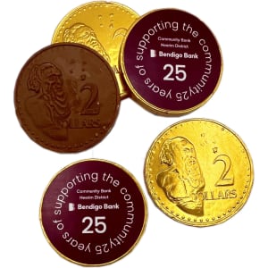 Chocolate coins in gold and brown, featuring monetary designs and a logo.
