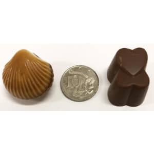 A chocolate selection featuring a shell-shaped chocolate and two heart-shaped chocolates, with a ten-cent coin for scale.