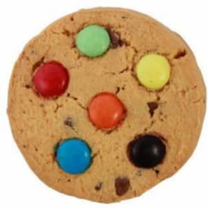 A round cookie with a golden-brown base topped with colourful chocolate buttons in green, yellow, orange, blue, and black.