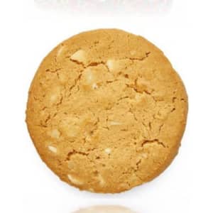 A round, golden-brown cookie featuring white chocolate and macadamia nuts, with a crumbly texture.